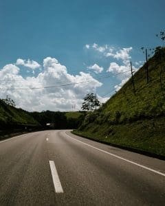 Curving highway surrounded by lush hills