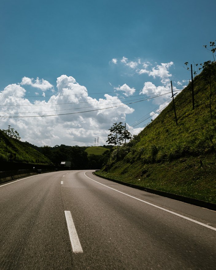 Curving highway surrounded by lush hills