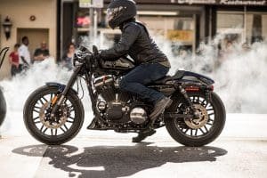 A motorcyclist wearing a helmet and leather jacket