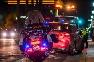 Police motorcycle stopped near a tow truck