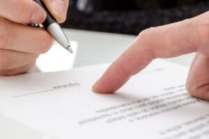 Woman signing a paper