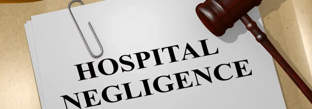 Document labeled "HOSPITAL NEGLIGENCE" with a paperclip, accompanied by a gavel, symbolizing legal issues in healthcare.