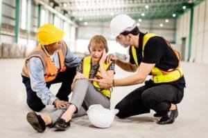 Two construction workers assist a woman in distress