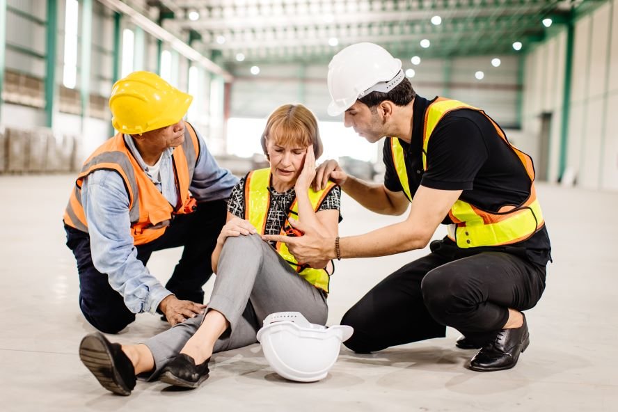 Two construction workers assist a woman in distress