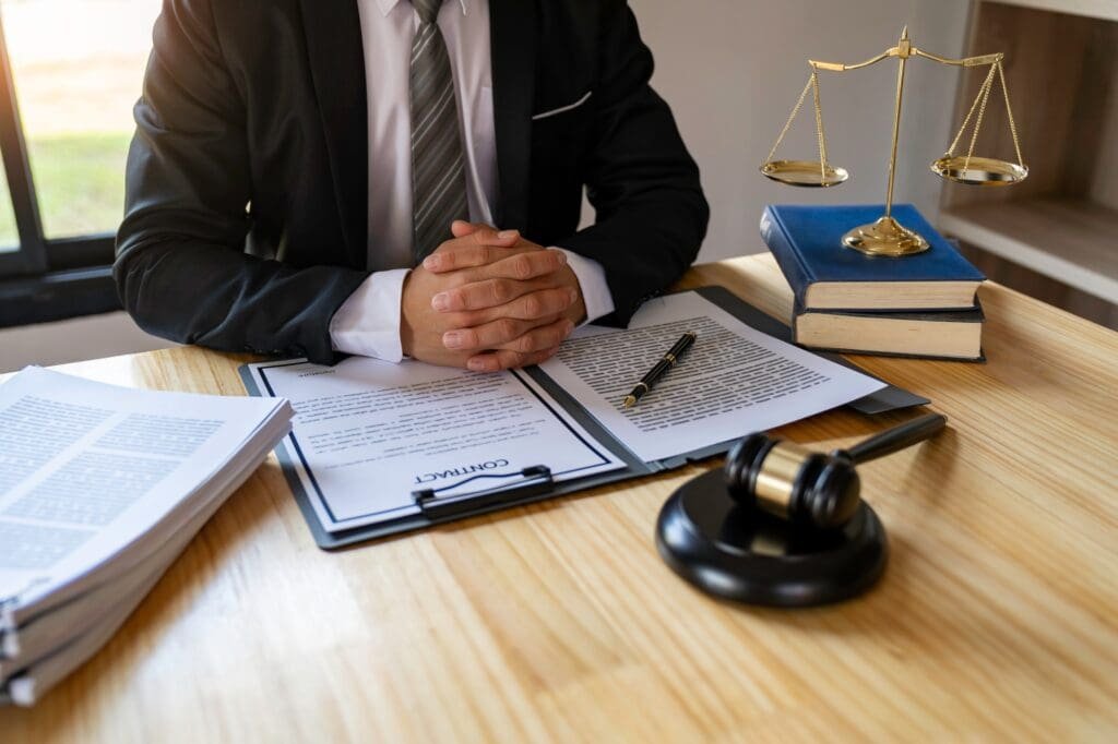 research attorney at a desk with files and books and scales of justice